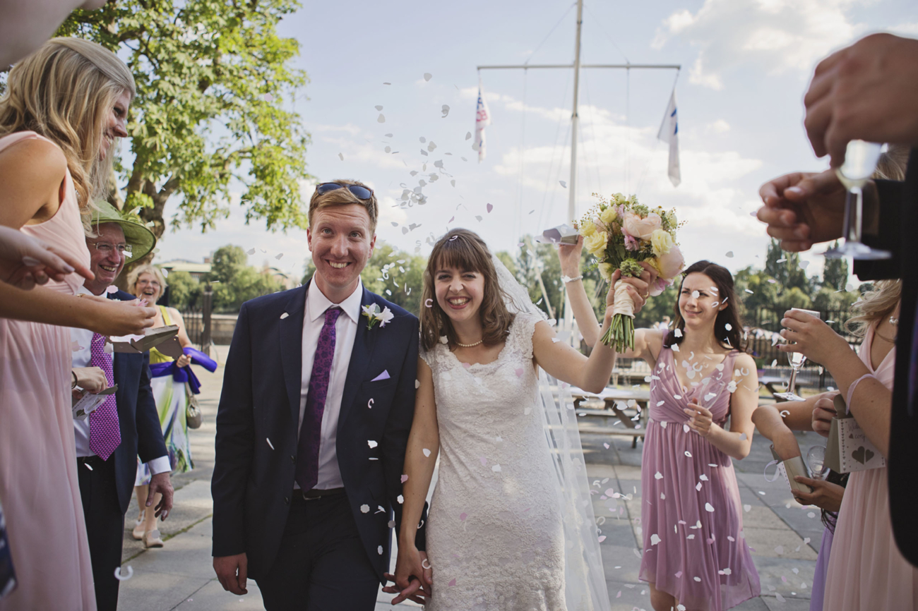 A bride and groom having confetti thrown over them outside Linden House, London