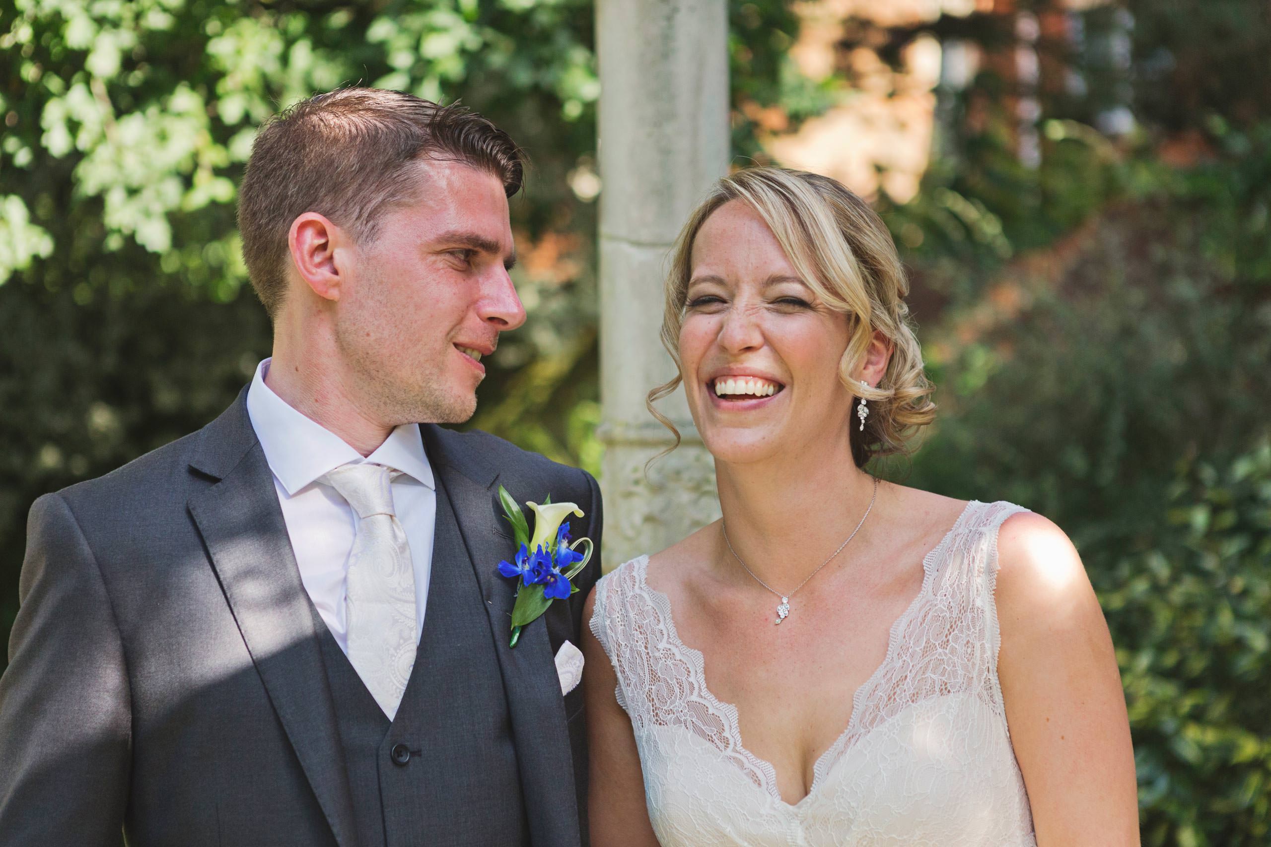 A bride & groom share a joke on their wedding day
