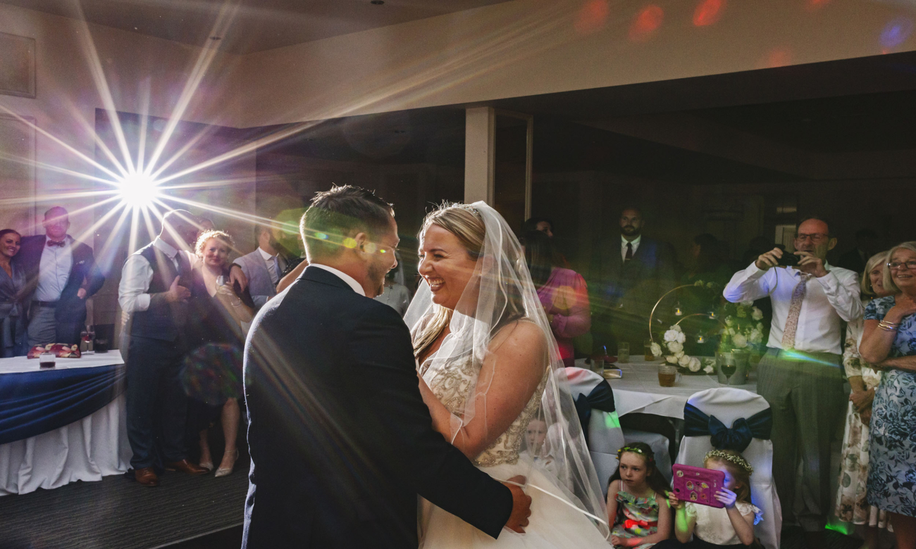 A newlywed couple enjoy their first dance as the Clifton Arms Hotel in Lytham as guests look on